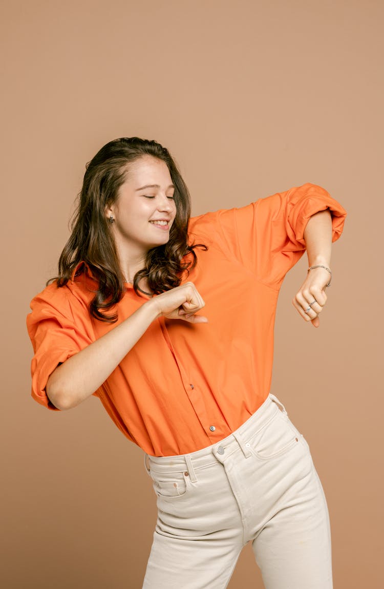 A Pretty Woman In Orange Shirt Dancing 