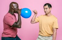 Man in Yellow Crew Neck T-shirt Holding Blue Balloon