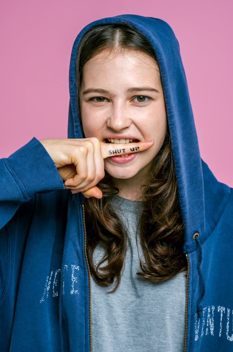 A Young Woman With A Shut Up Note On Index Finger