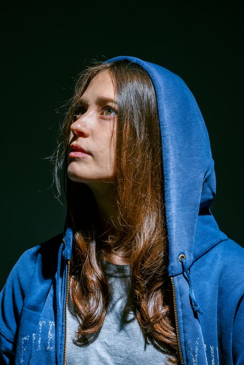 A Young Woman in Blue Hoodie Jacket Looking Up · Free Stock Photo