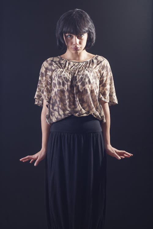 Woman Standing in Front of Black Surface