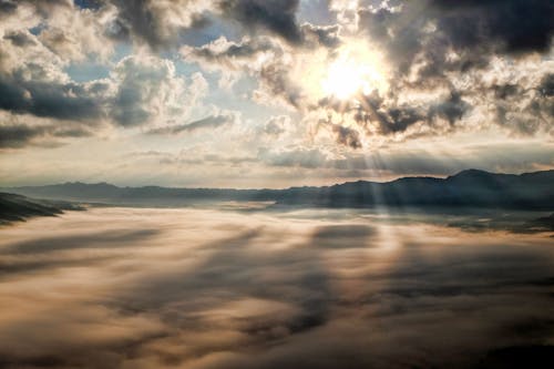 Free White Clouds With Sun Piercing Through It Stock Photo
