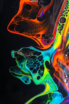 Colorful neon fluid art with dynamic swirls and bold contrasts in acrylic paint.