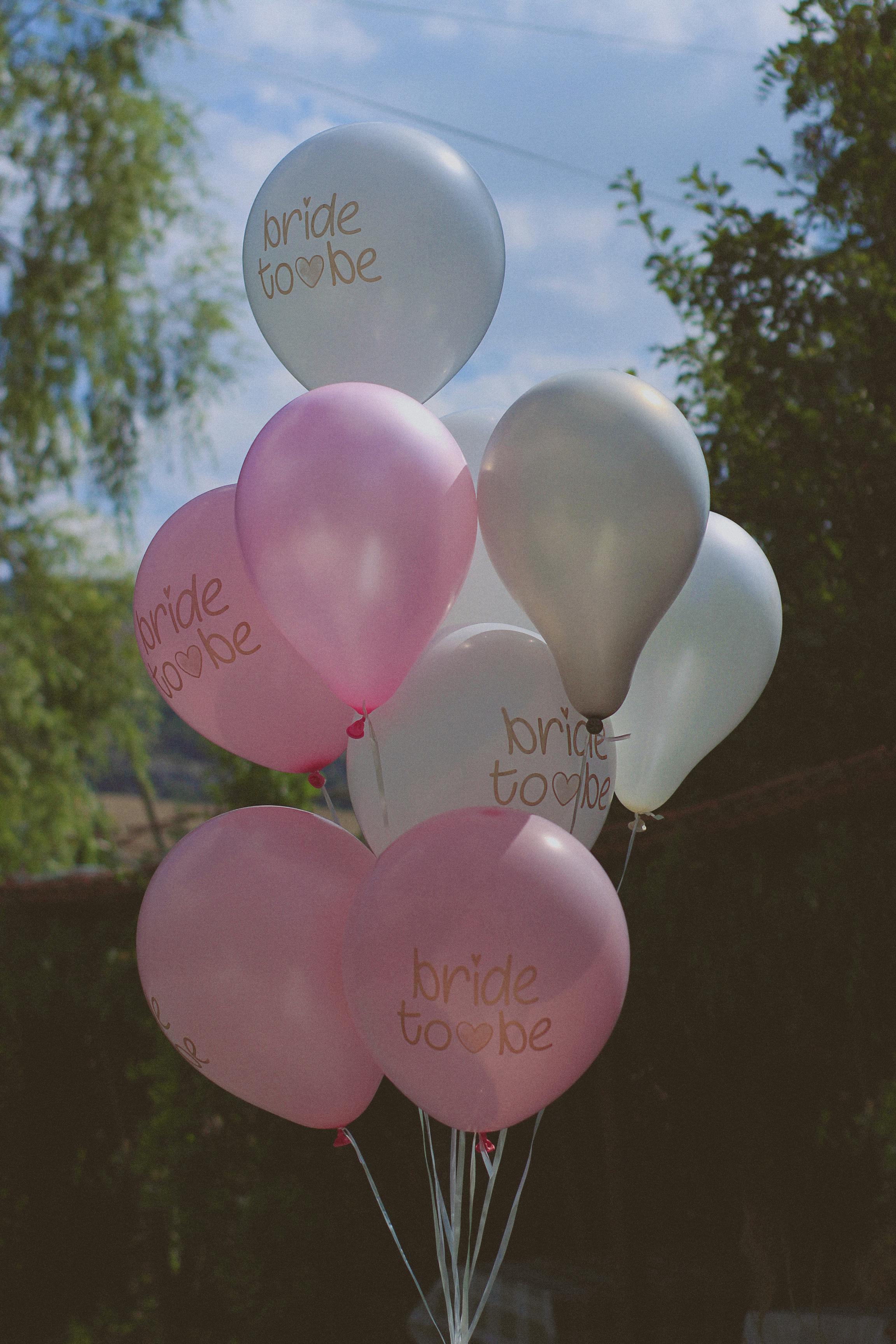 Cluster of Bride-to-Be balloons with pink and white colors in an outdoor setting. Ideal for celebrations.