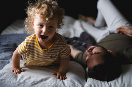 Free Man and a Boy on Bed Stock Photo