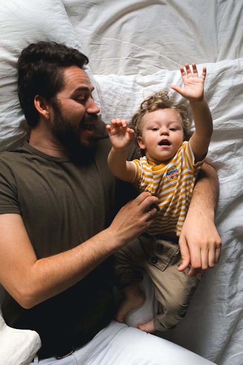 Free Man with his Son in Bed Stock Photo