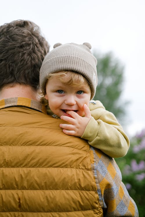 Free A Smiling Child on his Father's Arms  Stock Photo