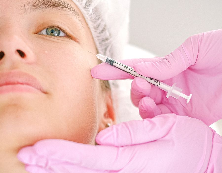 Cosmetologist administering facial injection at Aesthetic Haus Med Spa