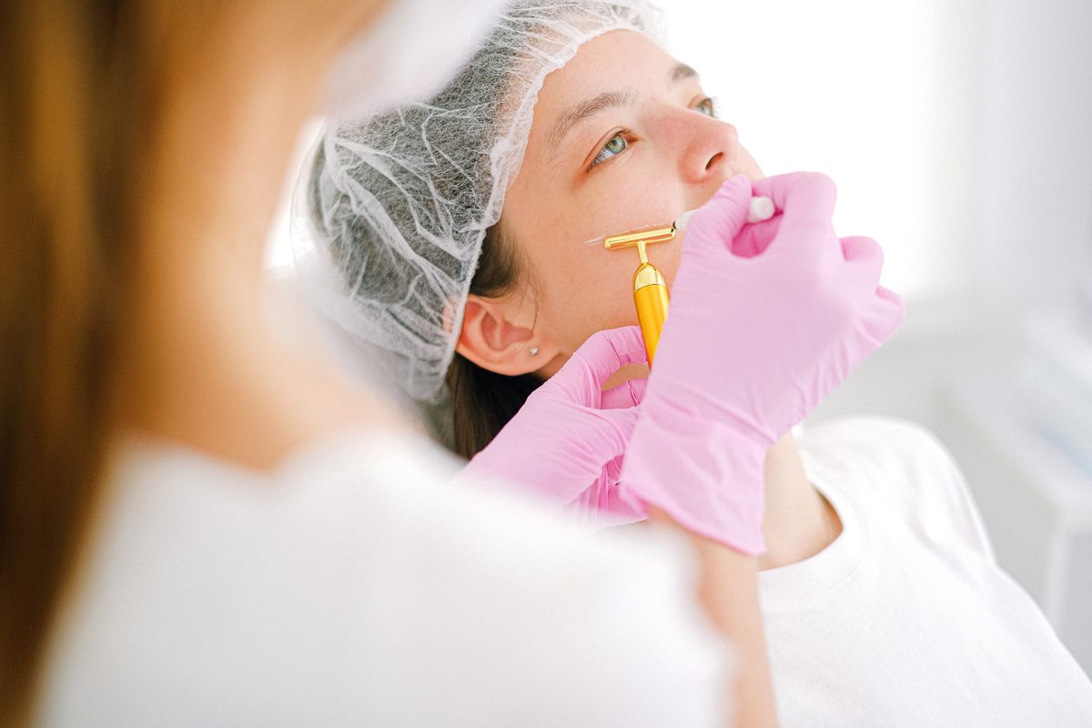 Dermatologist examining skin under magnification