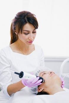 Aesthetician performing a facial skin care treatment on a woman at a beauty clinic.