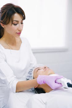 Aesthetician in a clinic using laser technology for a facial skin treatment on a patient.