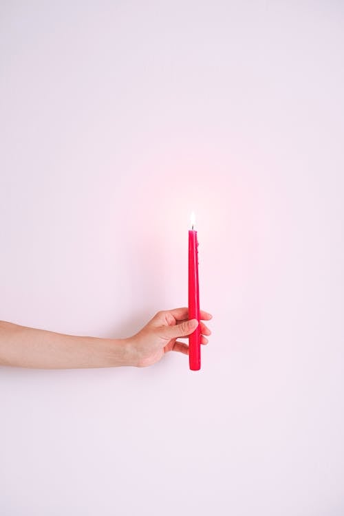 A Person Holding Red Candle