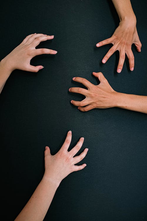 Hands Holding Black, Plain Surface