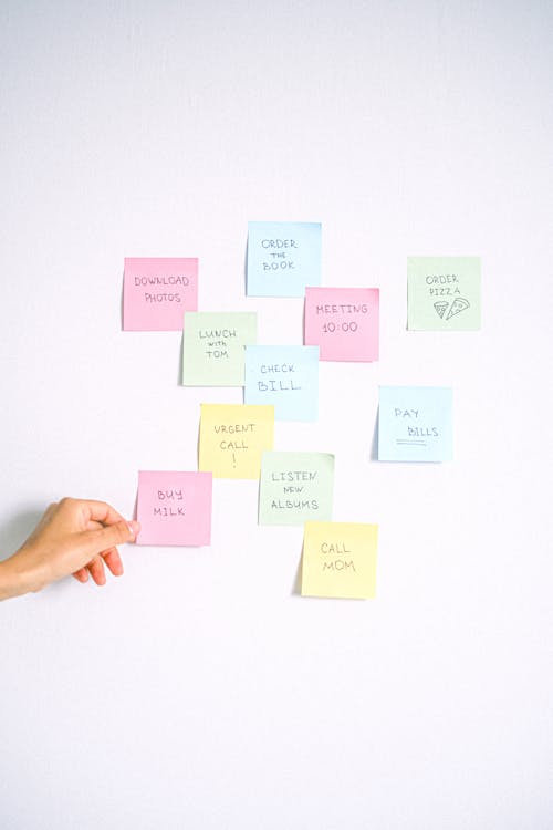 Woman Hand and Colorful Sticky Notes
