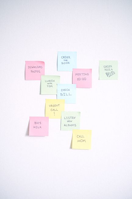 Colorful sticky notes arranged on a white background showcasing reminders and tasks. Colorful sticky notes arranged on a white background showcasing reminders and tasks.