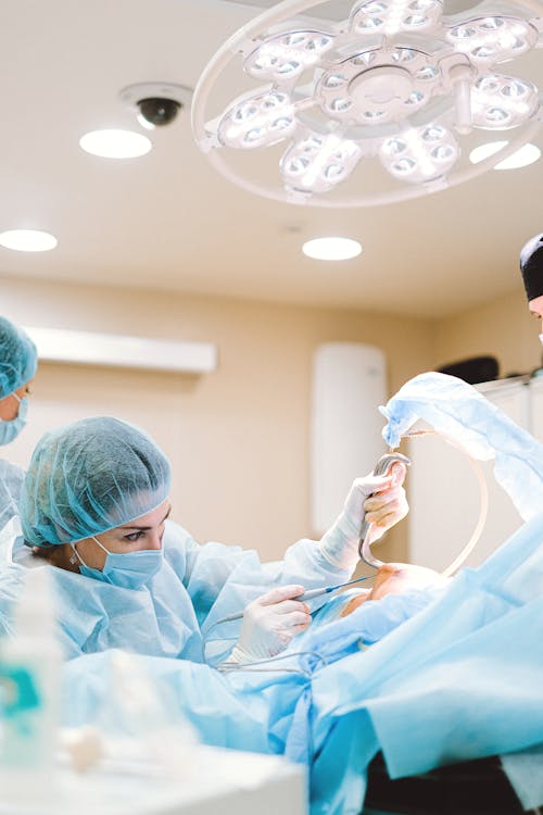 Woman in Blue Scrub Suit Operating