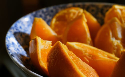 Free Sliced Orange Fruit in Blue and White Bowl Stock Photo