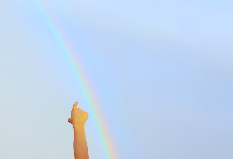 Childs Hand Pointing At Rainbow 