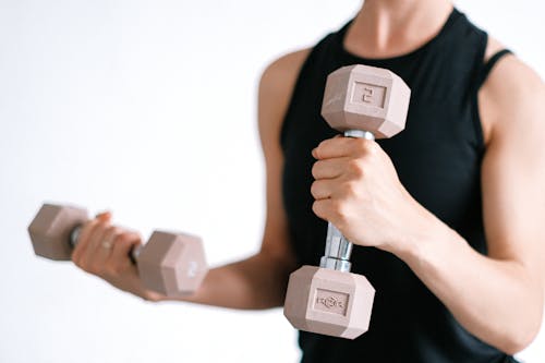 Free A Woman Holding Dumbbells Stock Photo