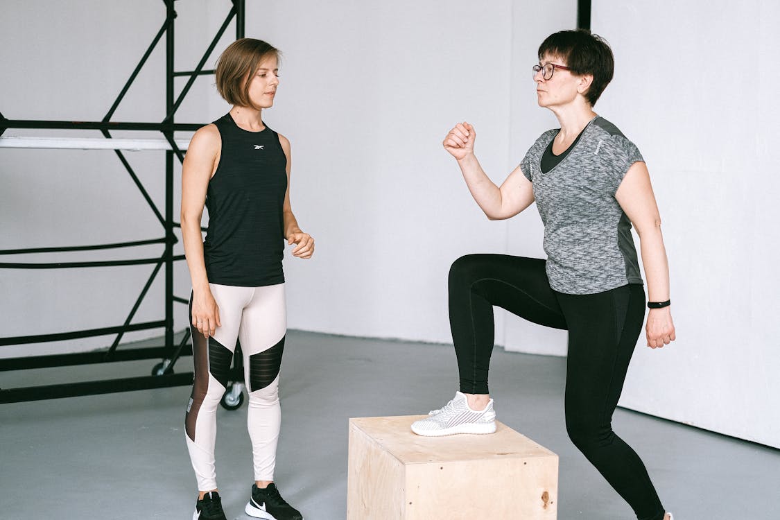 Woman taking a fitness class with an instructor.