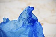 Blue Plastic Bag on White Sand