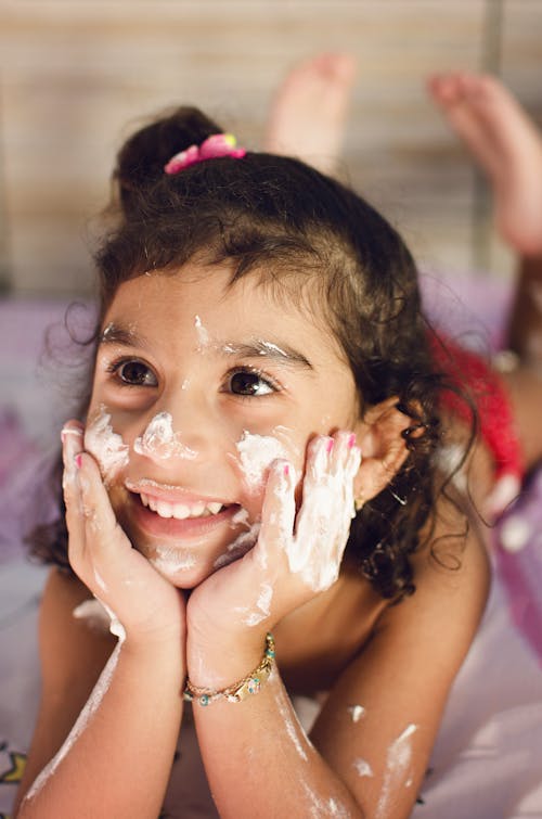 Free A Girl with a Cream on Her Face Stock Photo