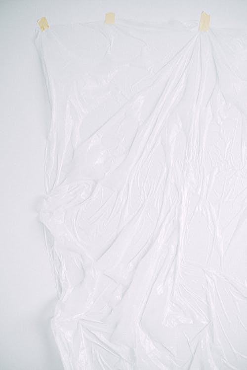 Photo of a Clear Plastic Taped on a White Surface