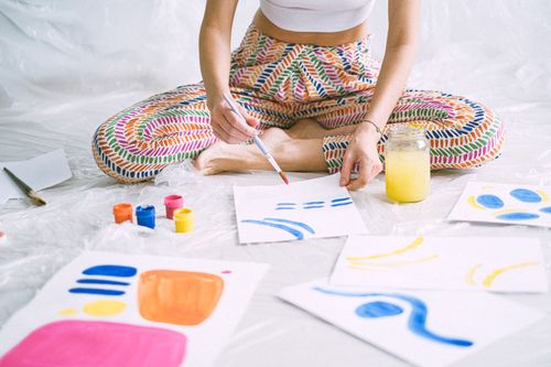 Free Vibrant art scene with colorful paints and papers in a creative workshop setting. Stock Photo