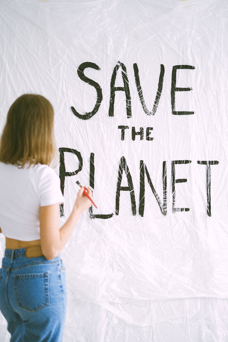 A Woman Writing A Message On White Surface 