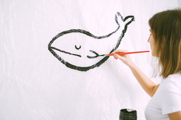 Photo Of A Woman Drawing A Whale 