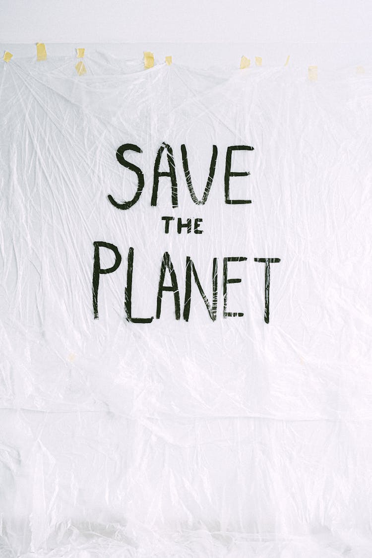 Save The Planet Text On White Textile