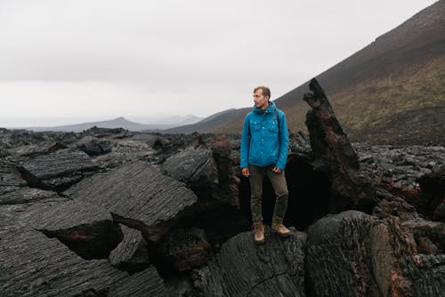 Man Standing on a Solidified Lava Rocks