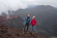 2 Women Standing on Brown Rock Formation