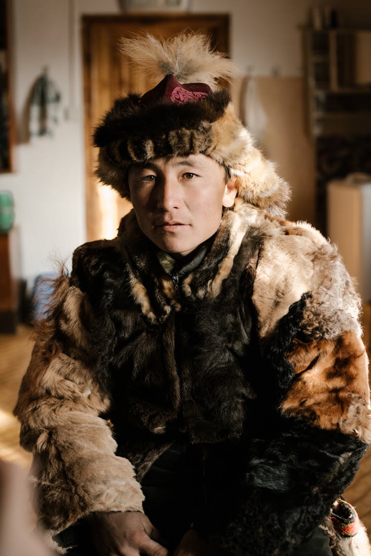 Mongolian Man In Traditional Furry Coat And Hat