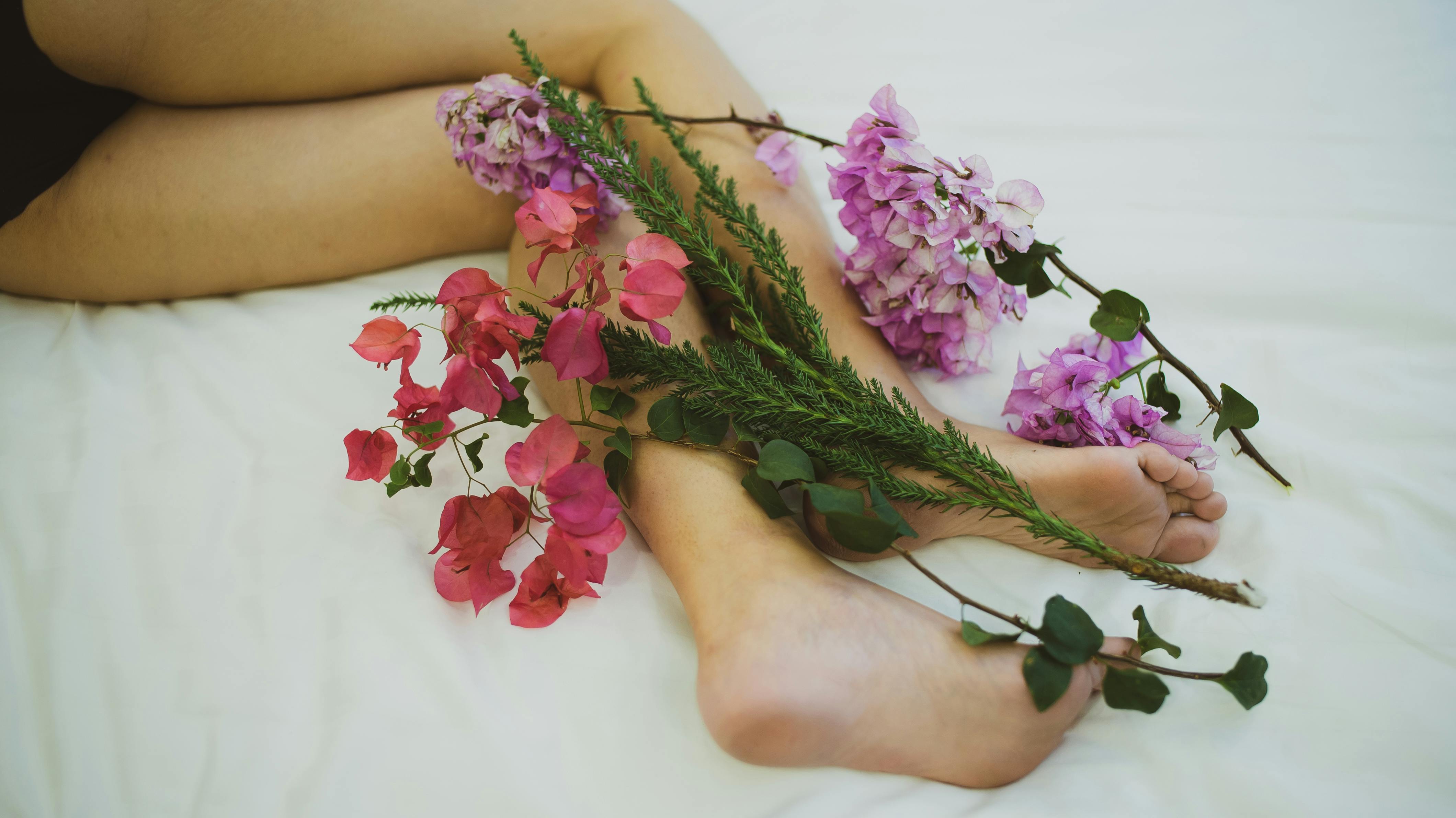 pink flowers on persons feet