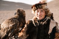 Man in Black Jacket Holding Brown Eagle