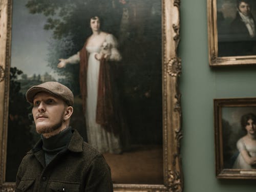 Man in Hat and Jacket in Art Gallery