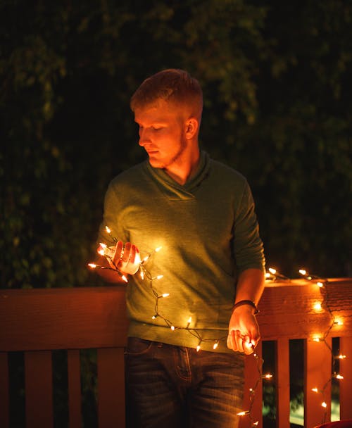 Man Holding Lit Fairy Lights