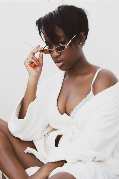 A Woman in White Robe Posing at the Camera