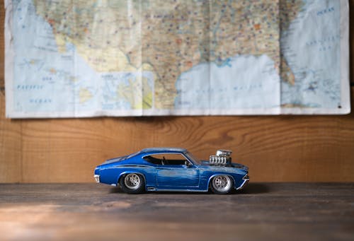 Close-Up Shot of Blue Chevrolet Camaro on Brown Wooden Surface