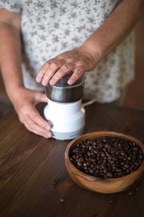 A Person Grinding Coffee Beans