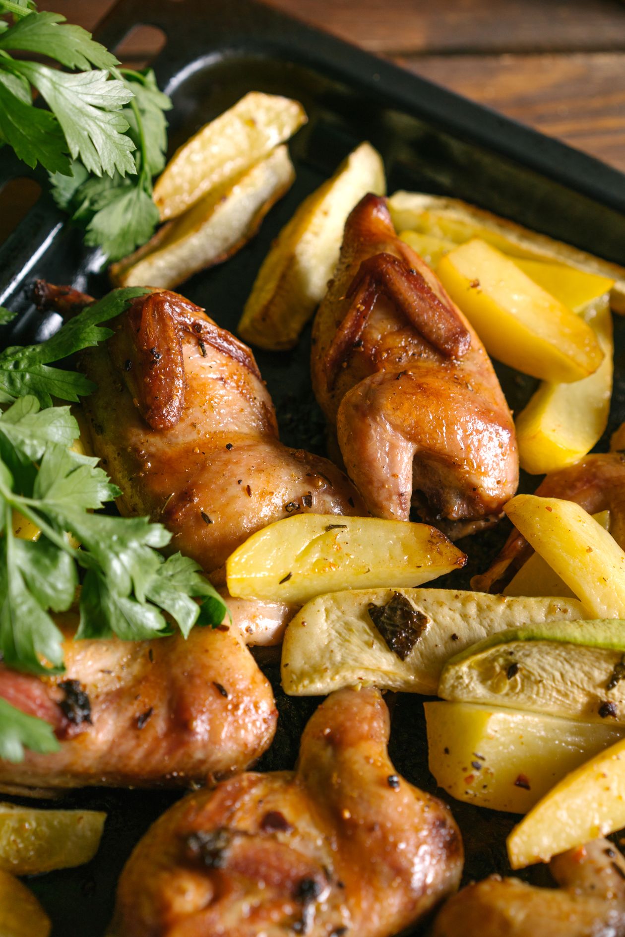 Oven baked jerk chicken thighs with crispy skin on a baking tray