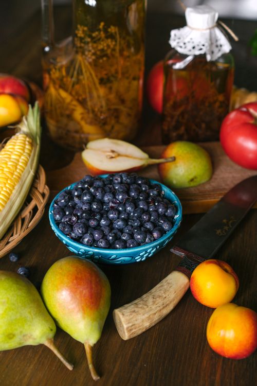 Free Assorted fresh fruits and vegetables displayed with kitchenware, perfect for food-related concepts. Stock Photo