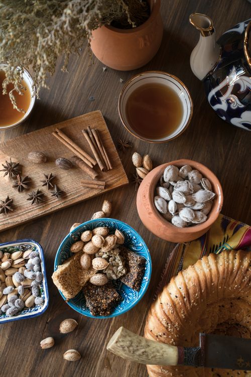 Free Cozy flat lay of nuts, spices, and tea on a rustic kitchen table setting. Stock Photo