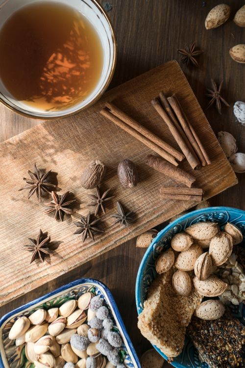 Free Top view of spices, nuts, and tea on a wooden board, perfect for autumn inspiration. Stock Photo