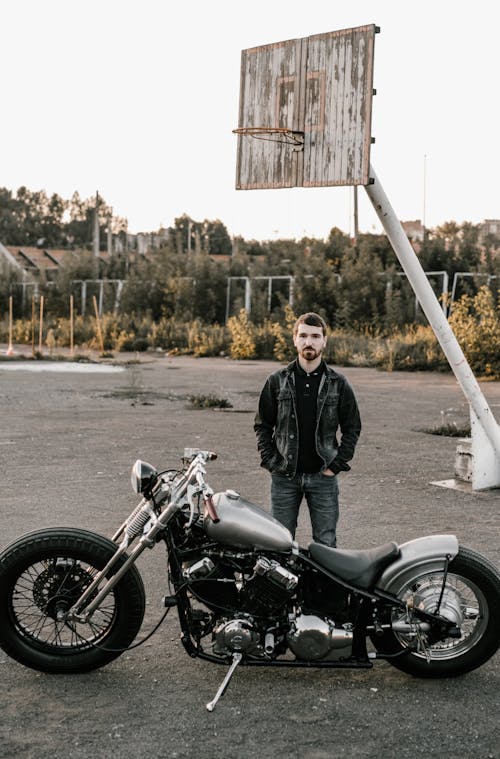 Man Standing Next to His Motorbike
