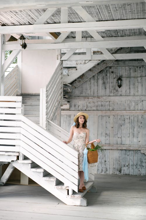 Woman Carrying a Shopping Basket Walking Down the Stairs