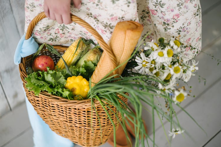 Woman Holding A Basket Full Of Fresh Food