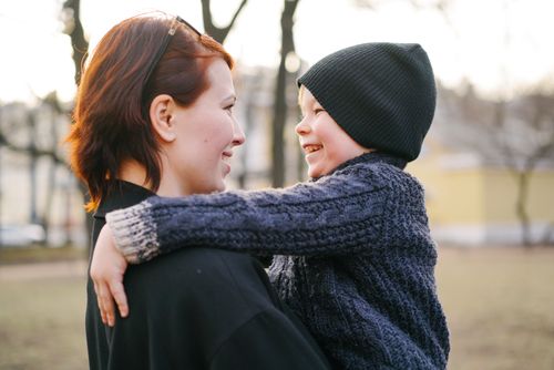 Free A loving moment between a mother and child in a park during fall afternoon. Stock Photo