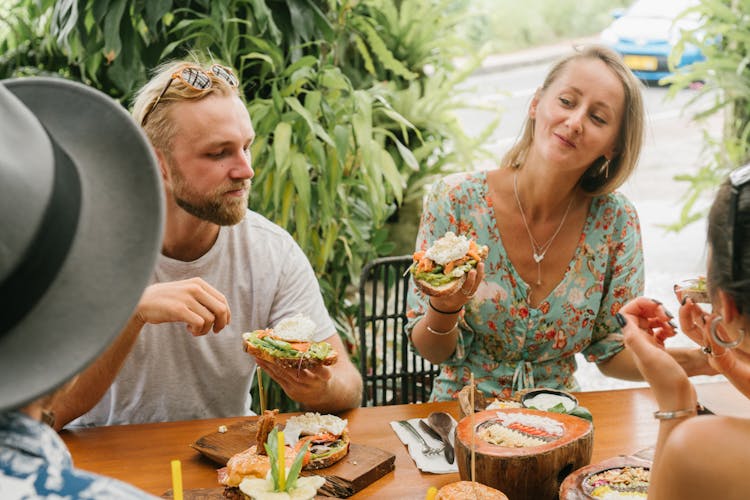 People Eating Sandwiches Together